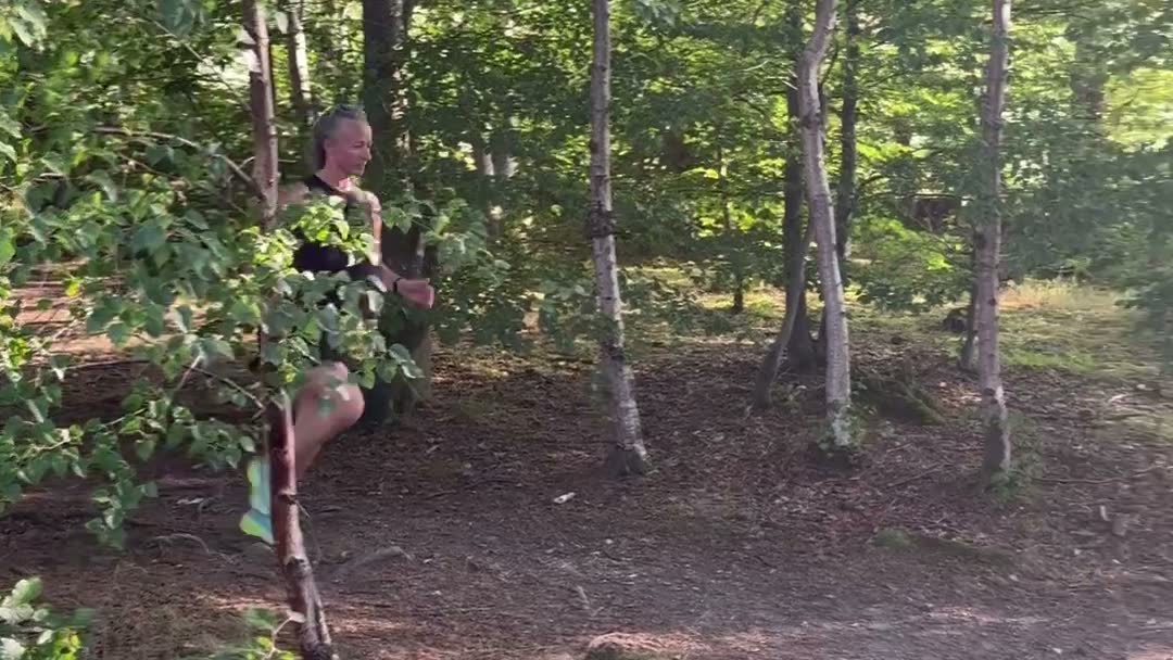 Carole running on a woodland trail in the Scottish Borders